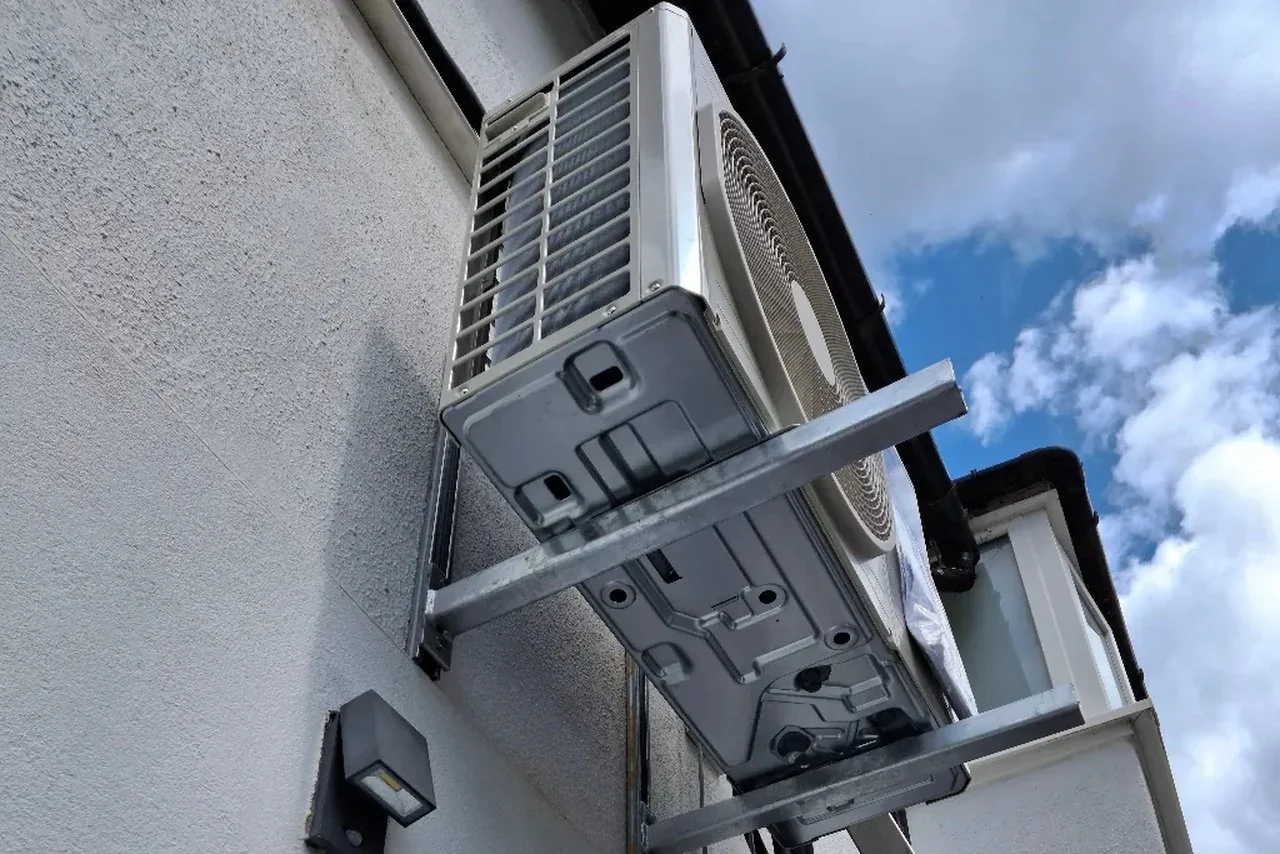 outdoor air conditioner unit installed on exterior wall