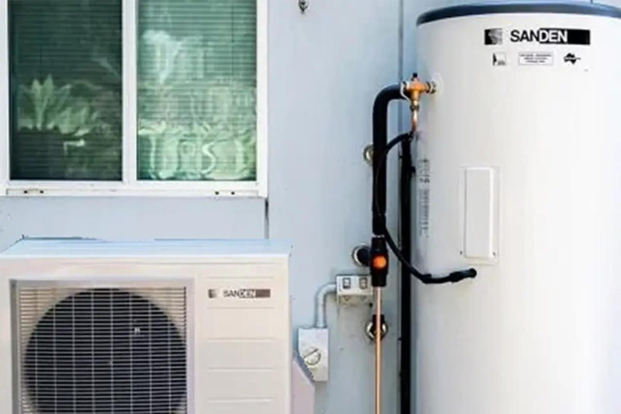 Technician inspecting and repairing refrigerator unit